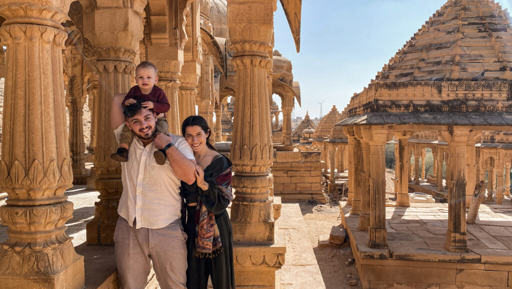 sweet mother and father with toddler son riding on shoulders at the Bada Bagh in Jaisalmer india