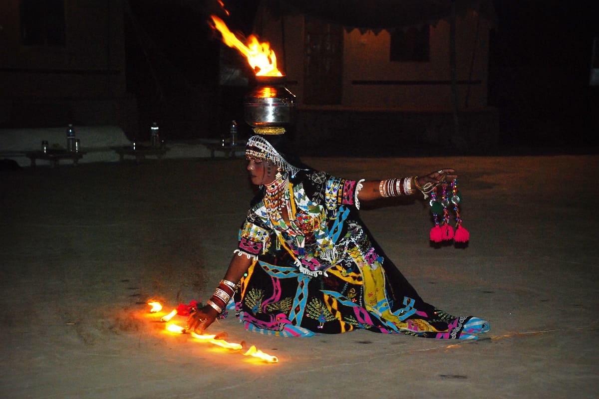 rajasthani fire dancer elaborately dressed in bright colors