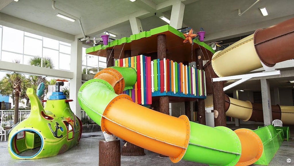 orange and green water slide in indoor waterpark