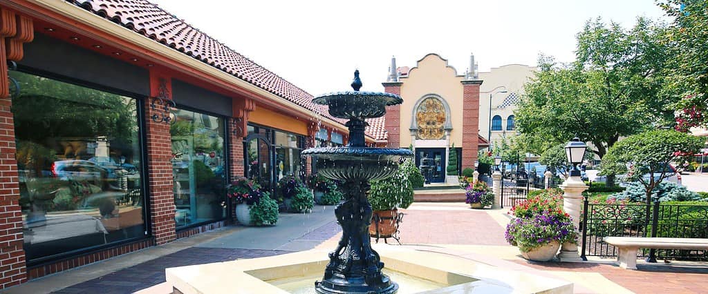 black water fountain outside in middle of shopping plaza