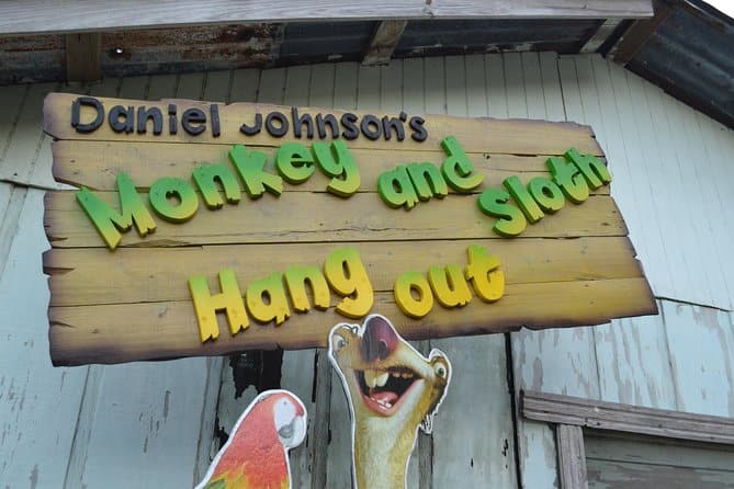 is it safe to travel to honduras on a cruise sign advertising a monkey and sloth hangout