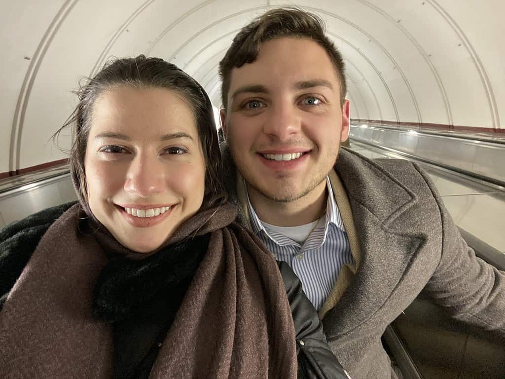 selfie of man and woman in head covering in tunnel