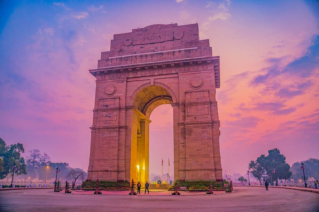 brown concrete Indian gate under blue and pink sky during daytime