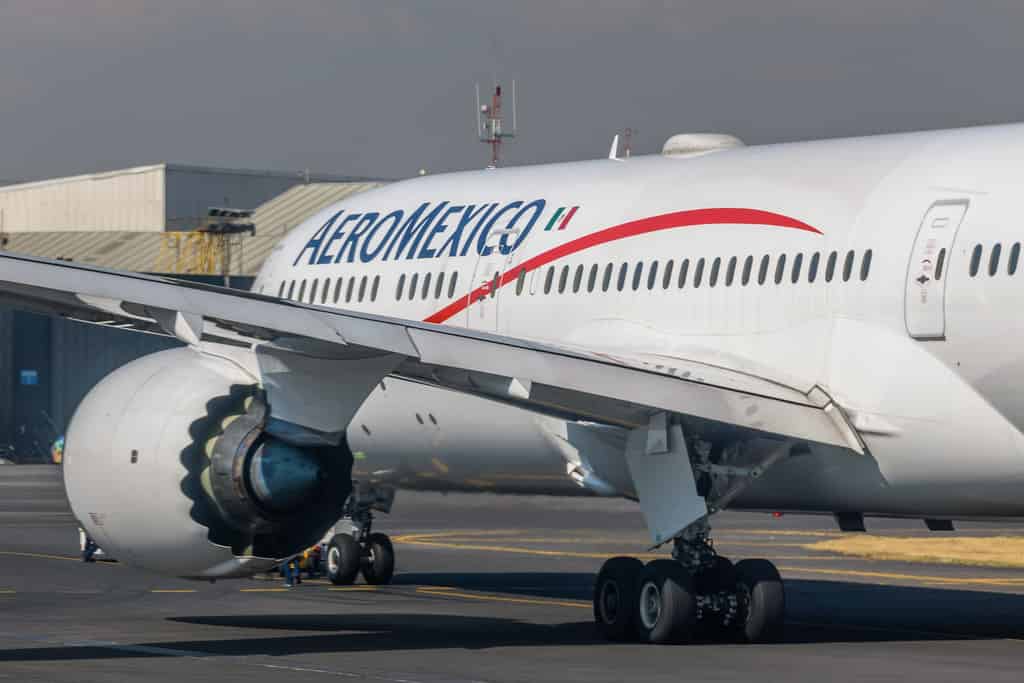 White Aeromexico airplane parked on tarmac