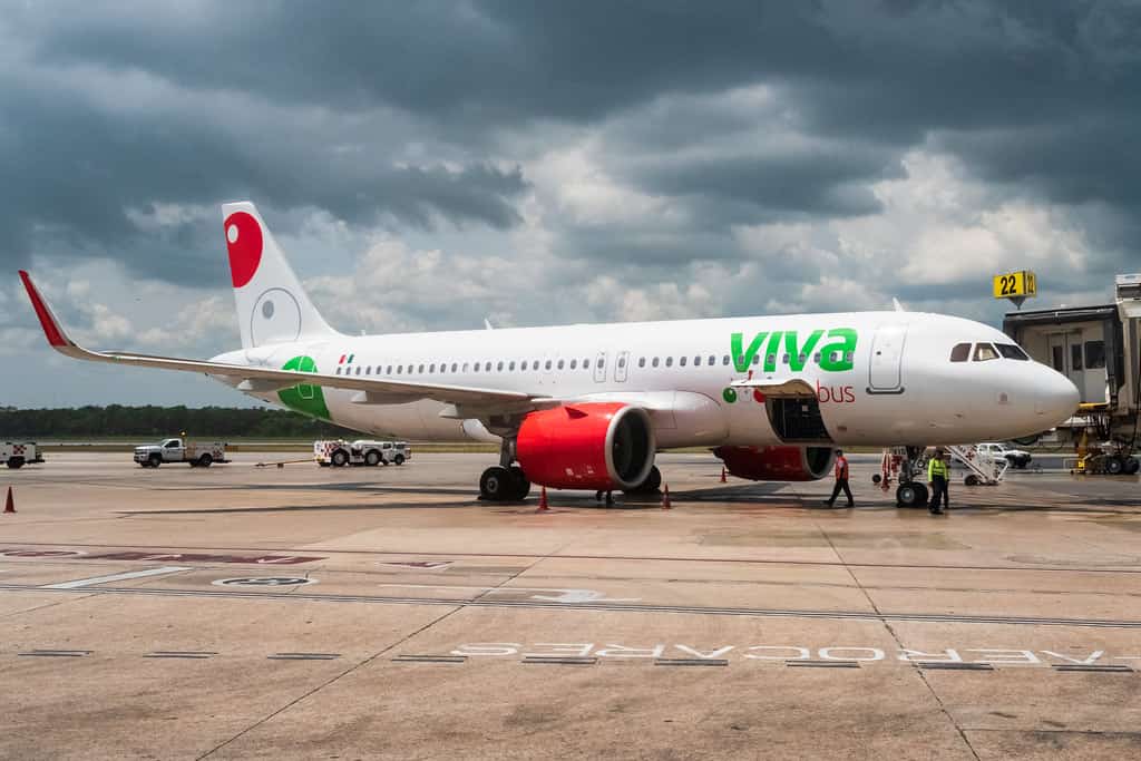 white viva aerobus airplane on tarmac on cloudy day