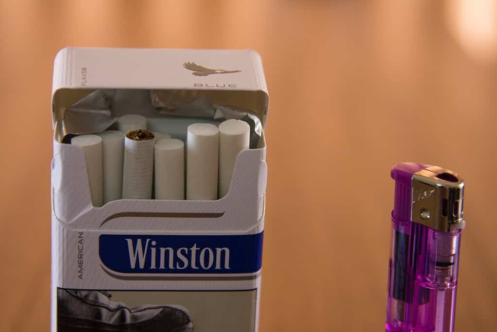 a box of cigarettes and a lighter on a table