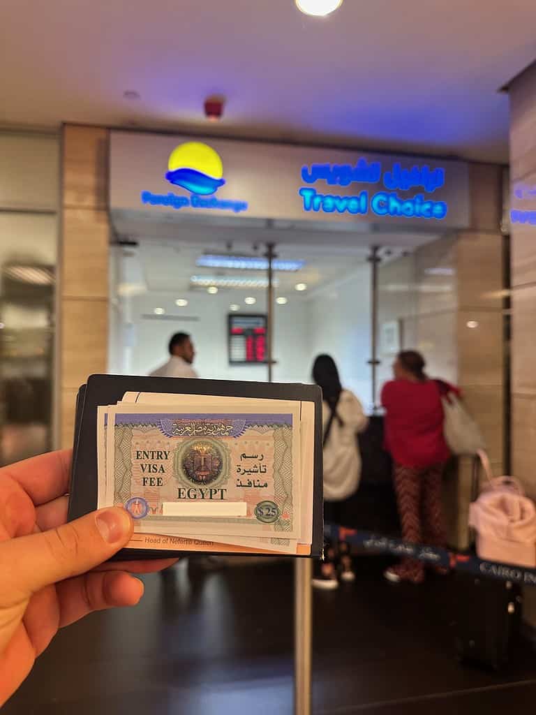 man holding an Egyptian visa in cairo airport