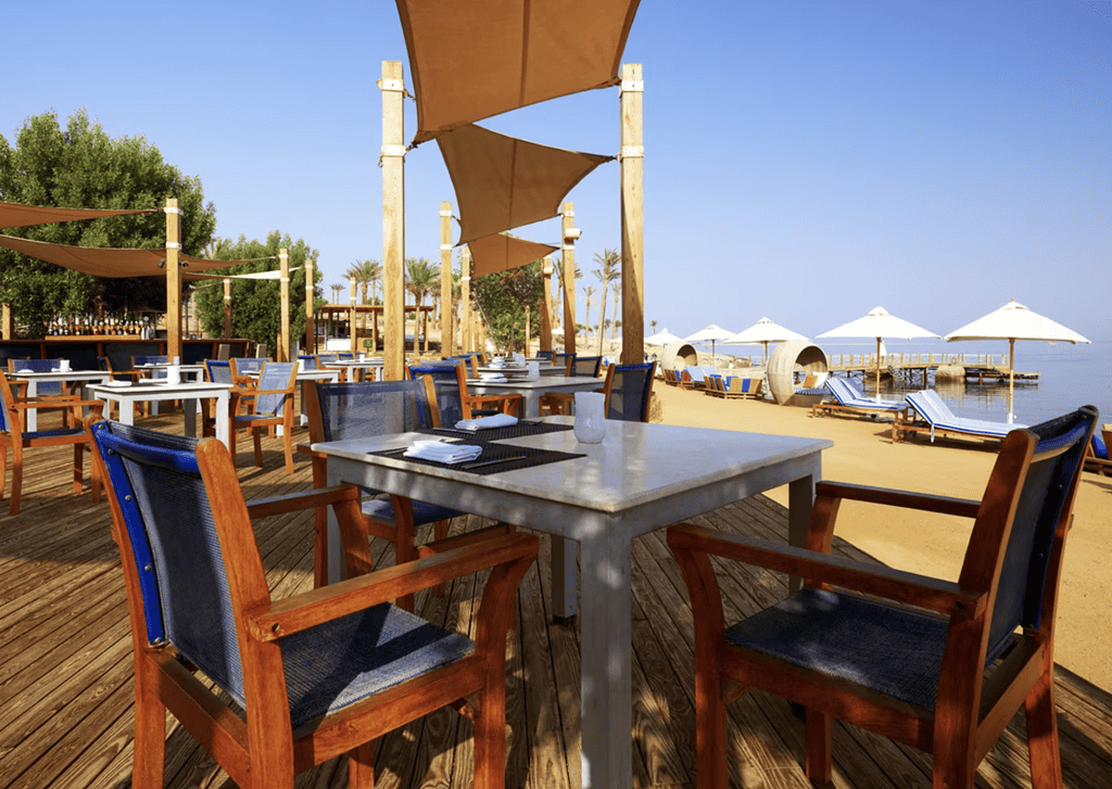 restaurant tables resting on a beach