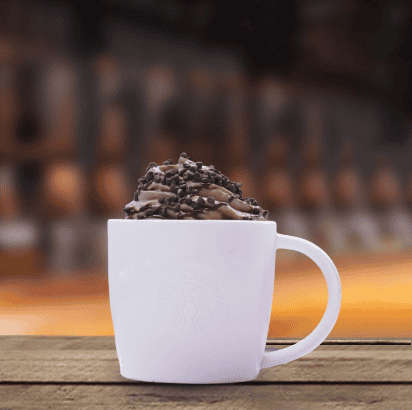 a starbucks chocolate latte with chocolate whipped cream in a white mug