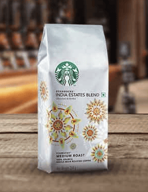 white bag of starbucks coffee beans with colorful suns